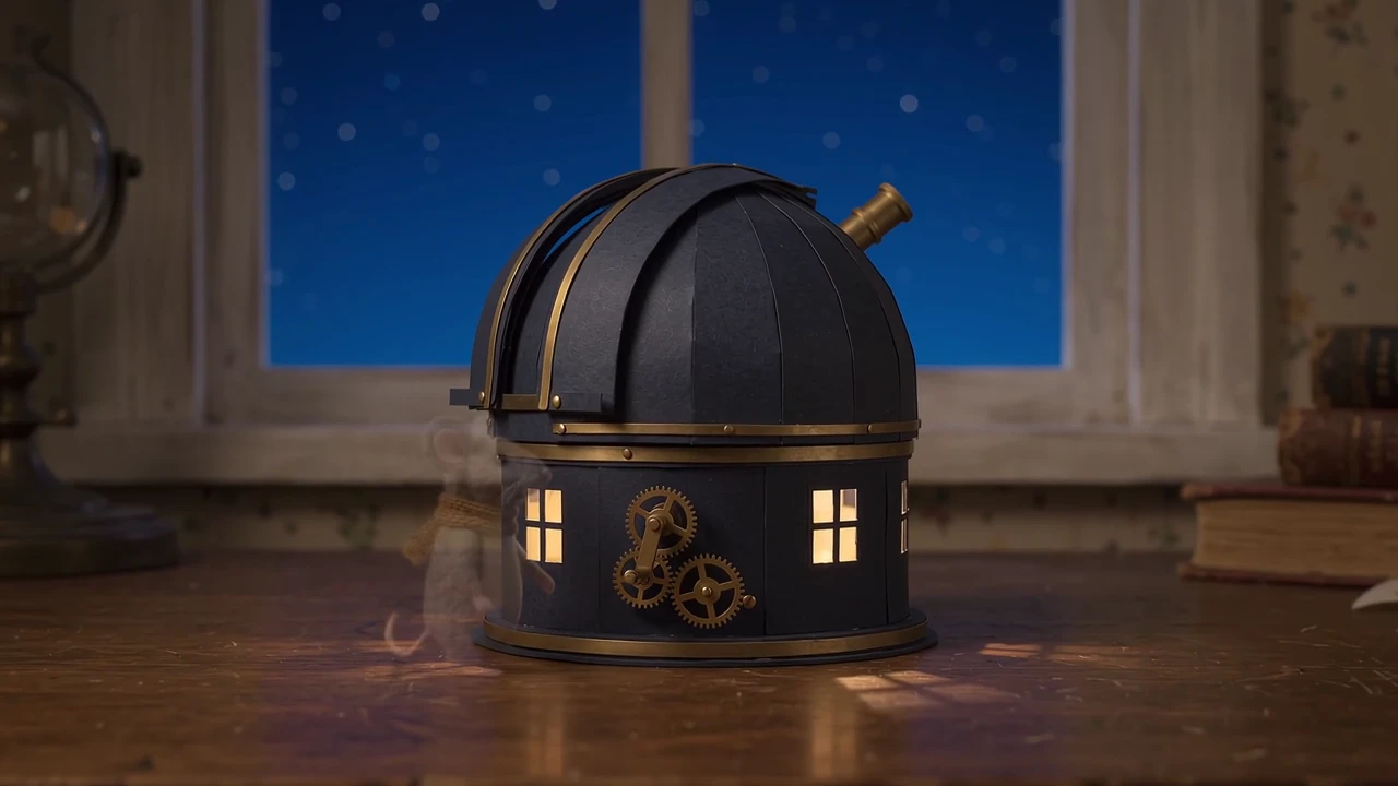A felt mouse turns the brass crank as the observatory opens. Follow the gears and the telescope emerging from the dome.